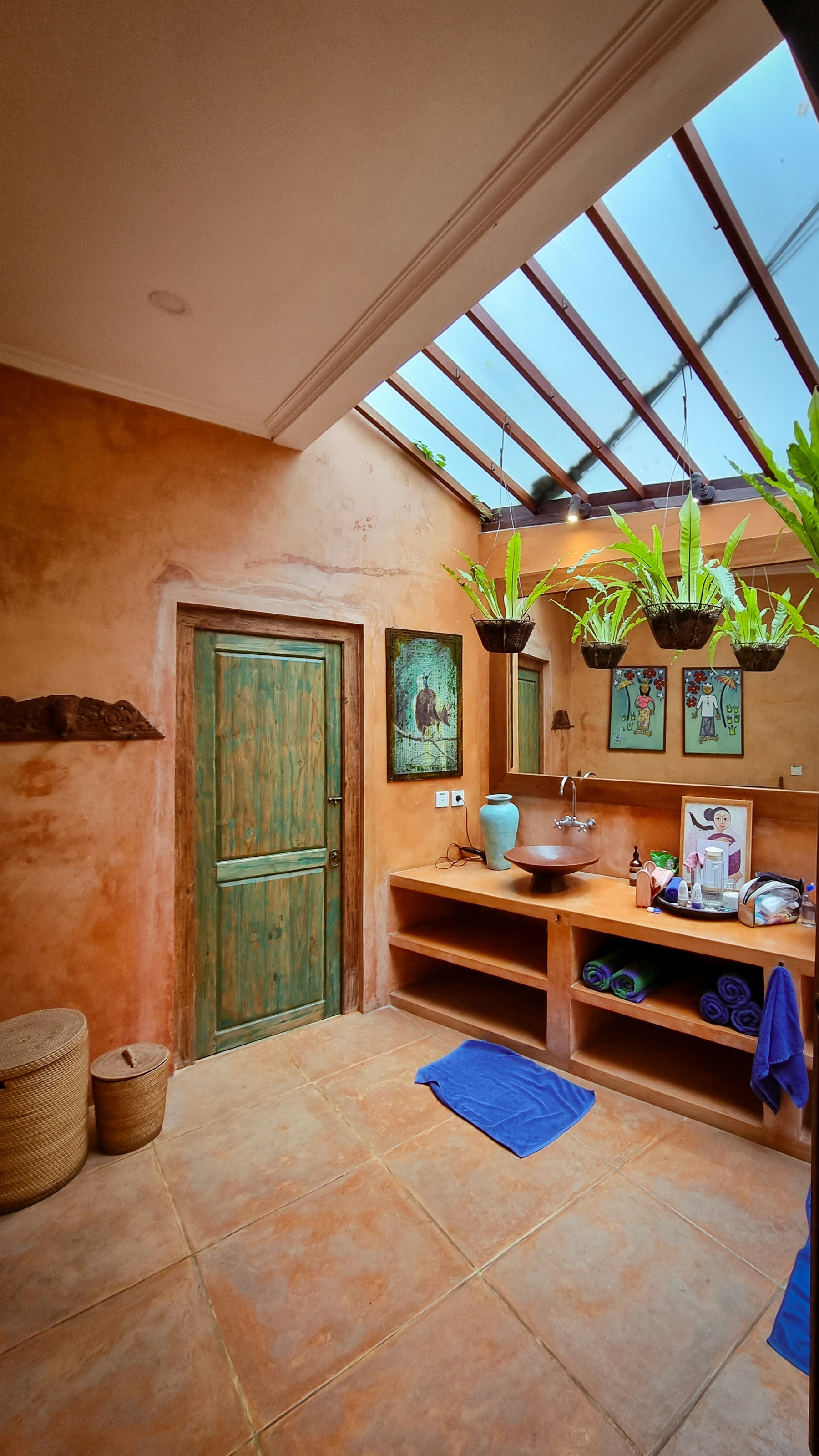Sunlit bathroom with a skylight, earthy tile, and natural materials